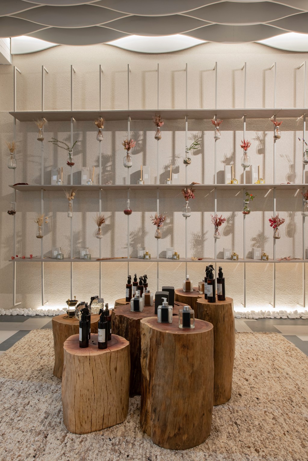 renata-pisani-loja-de-aromas-casacor-parana-2023-credito-duas-fotografia Renata Pisani - Loja De Aromas. Projeto da CASACOR Paraná 2023. Na foto, loja de perfumes com vasos e troncos como mesa.
