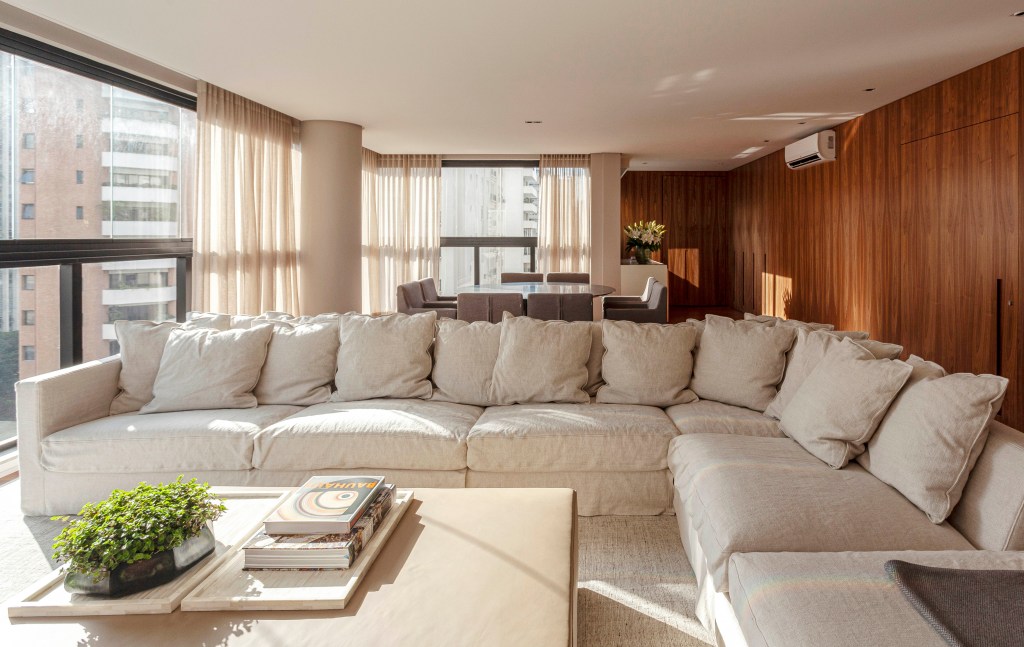 david-bastos-apartamento-classico-174-m2-sao-paulo-credito-tuca-reines (9) David Bastos assina apartamento clássico de 174 m² em São Paulo. Na foto, sala de estar e de jantar com paredes de madeira e quadros,