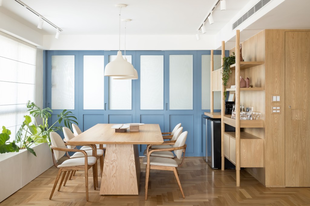Apê eclético: minimalismo, shabby chic e industrial se mesclam em 180 m². Projeto Studio Lak. Na foto, sala de jantar com porta azul e pendentes.